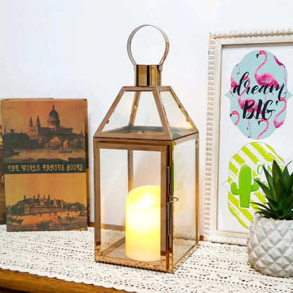 16-inch high decorative lantern with gold metal frame, glass panels, candle inside