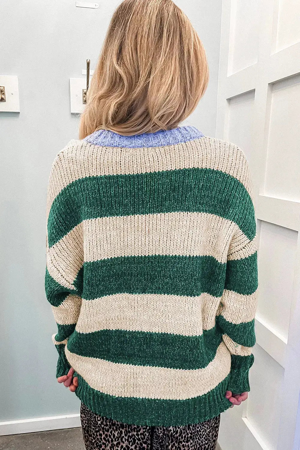 Striped colorblock drop-shoulder pullover sweater with beige and green stripes and blue ribbed collar.