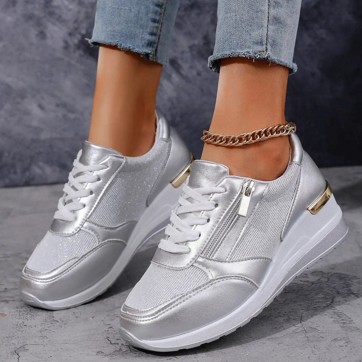 Women's metallic silver lace-up casual sneakers with side zipper and chunky white sole.