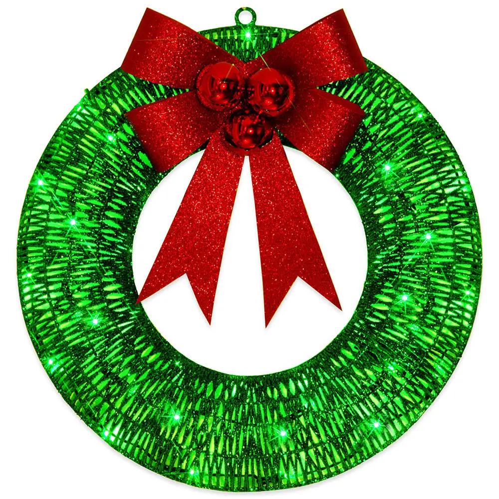 Christmas wreath with green LED lights and red glitter bow for front door decor.