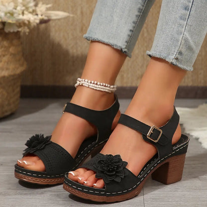 Women's flower-embellished black sandals with chunky heel, platform sole, and ankle strap buckle
