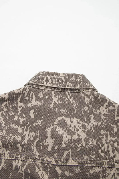Abstract print denim jacket; long sleeves with raw hem, back view in gray-taupe denim