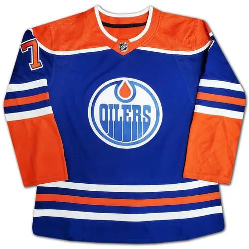 Autographed Edmonton Oilers jersey, blue with orange sleeves, features large team logo on front at center.
