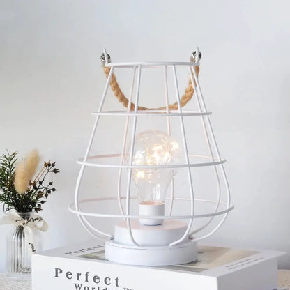 Cordless accent lamp by JHY DESIGN, white metal cage with Edison-style bulb.