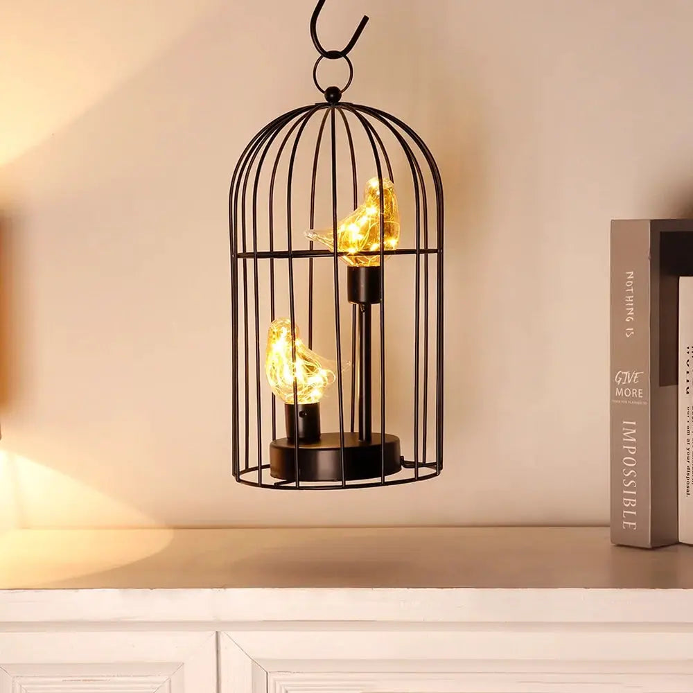 12-inch tall battery-operated birdcage lamp with two bird-shaped lights in a black metal cage by JHY DESIGN